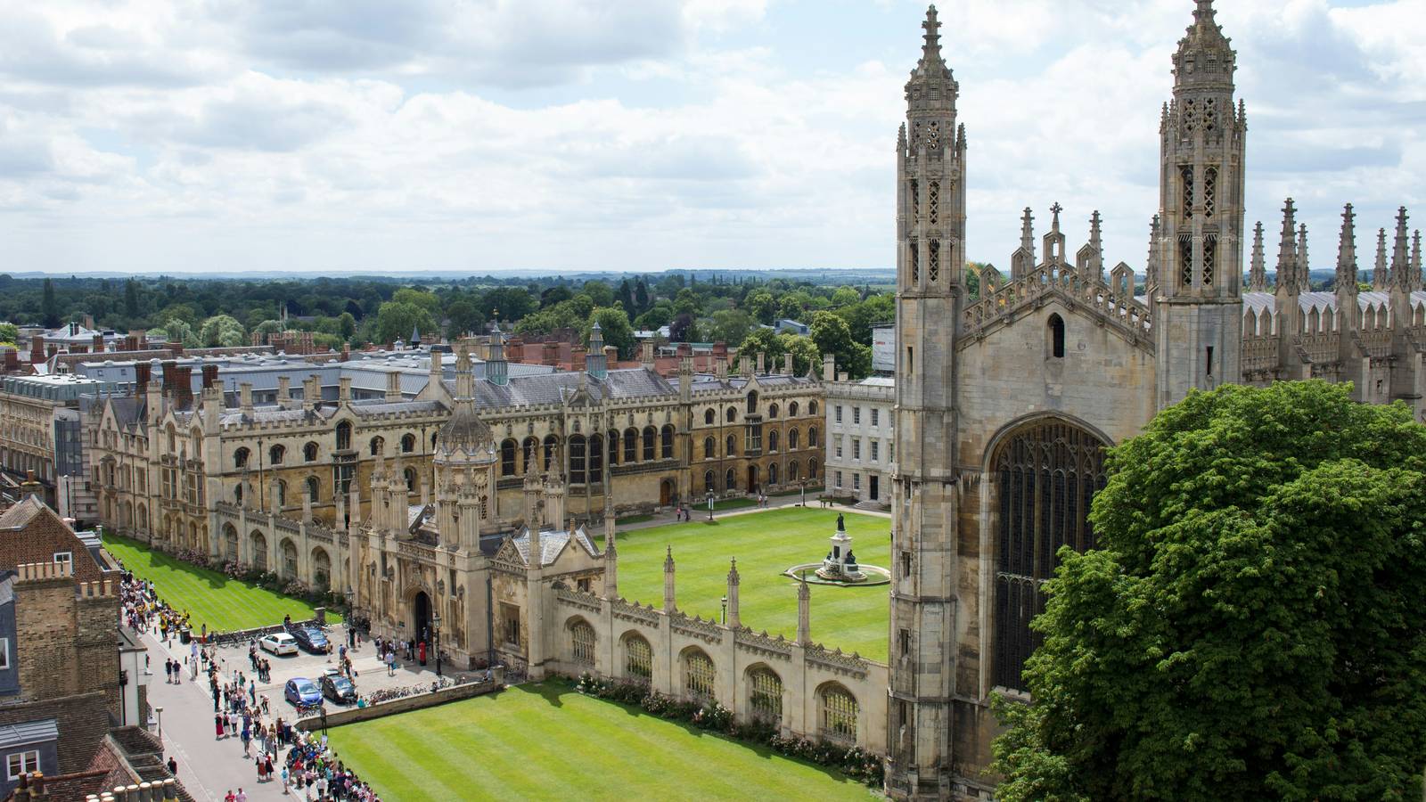 Cambridge seen from above, with the stone pinnacles of King's College Chapel, its courtyard and lawns, and the street beyond